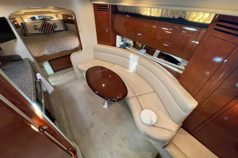 Slide: The Image of Luxurious interior of 2006 Sea Ray 360 Sundancer with curved seating and elegant wood finishes. - 26