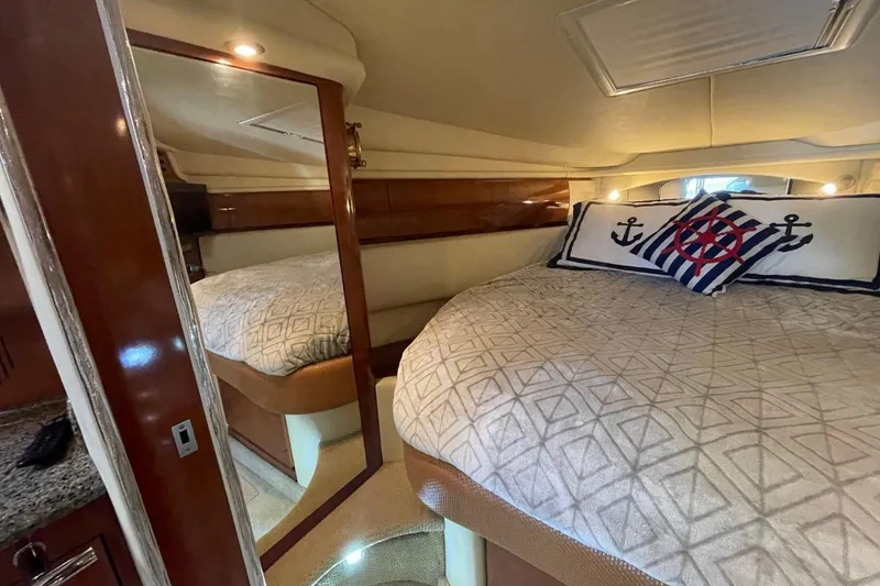 Slide: The Image of Luxurious cabin interior of 2006 Sea Ray 360 Sundancer with nautical-themed bedding. - 31