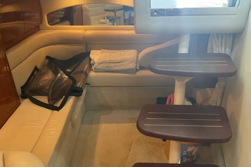 Slide: The Image of Interior of 2006 Sea Ray 360 Sundancer with beige seating and wooden steps. - 33