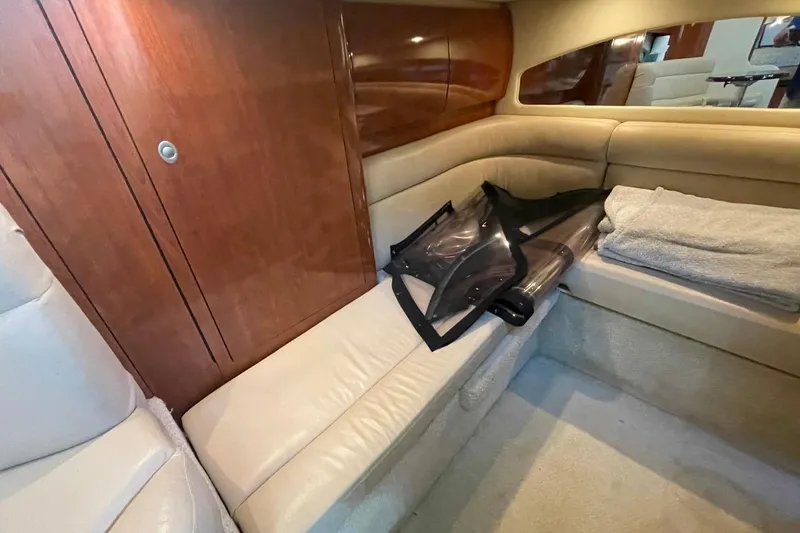 Slide: The Image of Interior cabin of 2006 Sea Ray 360 Sundancer with beige seating and wooden paneling. - 34