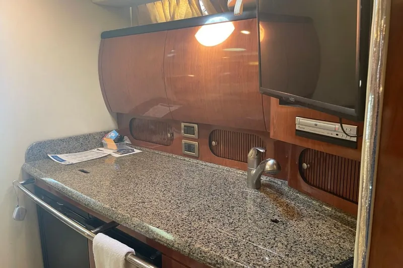 Slide: The Image of 2006 Sea Ray 360 Sundancer interior with granite countertop, sink, and mounted TV. - 36