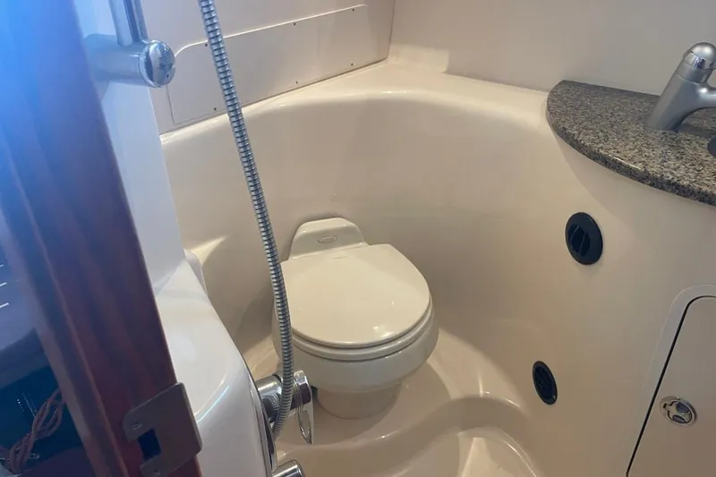 Slide: The Image of 2006 Sea Ray 360 Sundancer bathroom with toilet, shower, and granite countertop. - 37