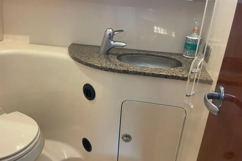 Slide: The Image of 2006 Sea Ray 360 Sundancer bathroom with granite countertop and modern fixtures. - 38