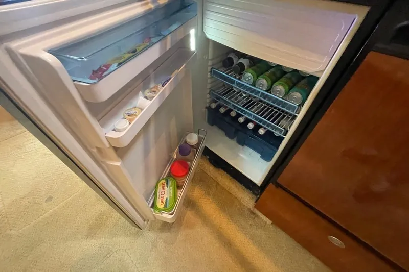 Slide: The Image of Open fridge on 2006 Sea Ray 360 Sundancer, stocked with drinks and condiments. - 43