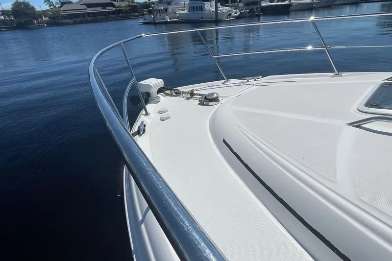 Slide: The Image of 2006 Sea Ray 360 Sundancer docked, featuring sleek design and spacious deck area. - 52