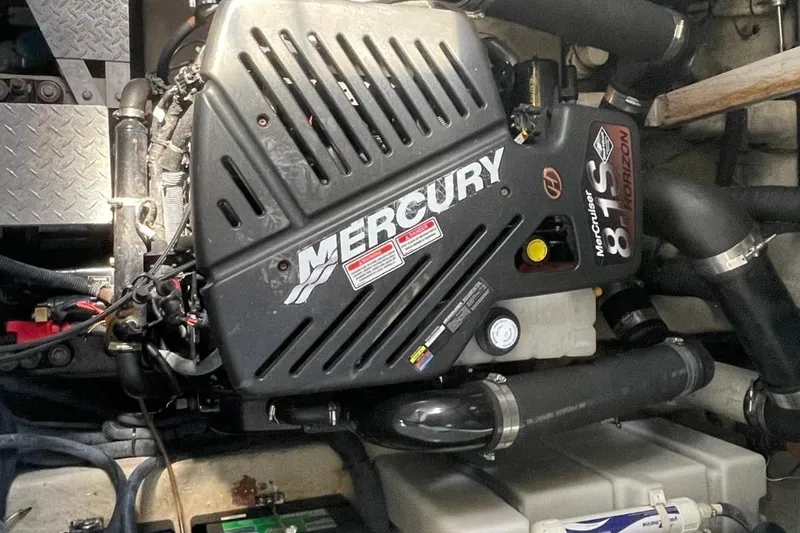 Slide: The Image of Engine compartment of a 2006 Sea Ray 360 Sundancer with Mercury components. - 56