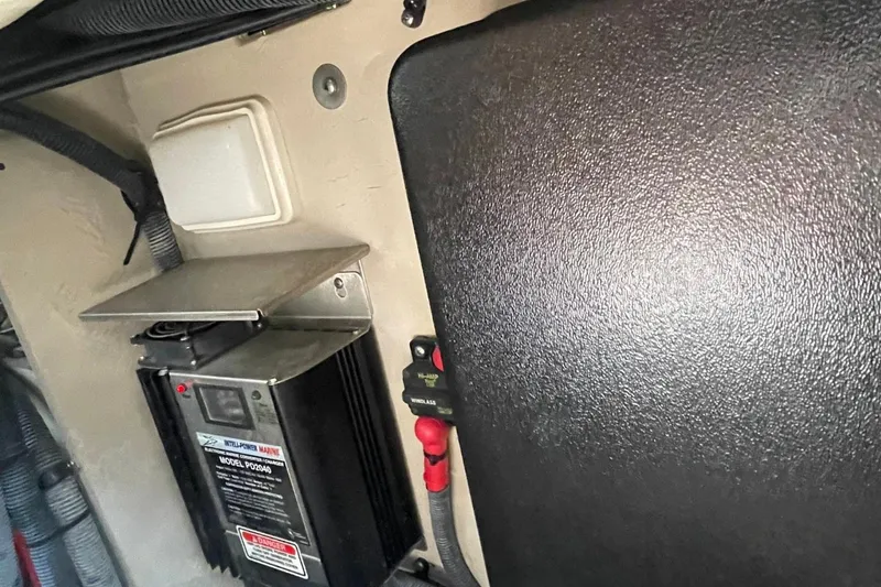 Slide: The Image of Engine compartment of a 2006 Sea Ray 360 Sundancer with fire extinguisher and control panel. - 58