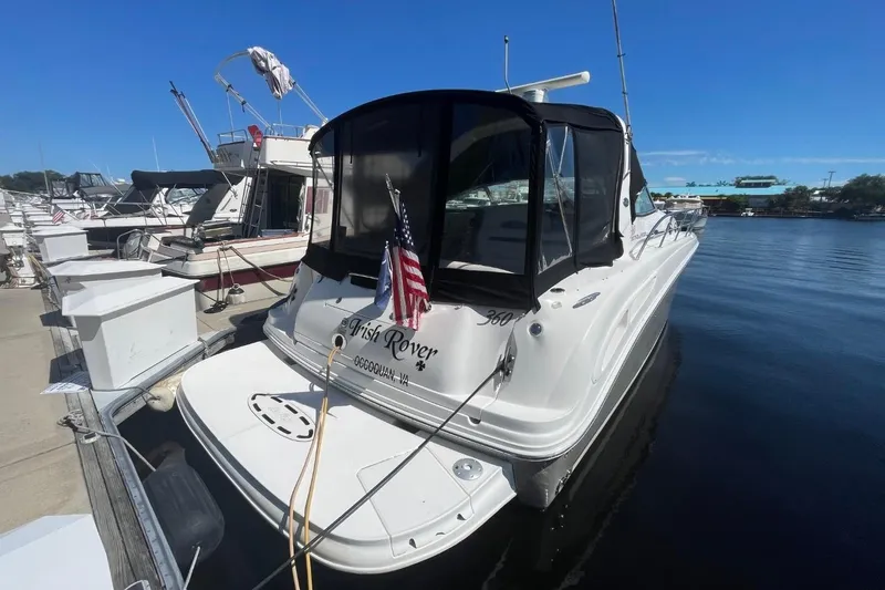 Slide: The Image of 2006 Sea Ray 360 Sundancer docked at marina, rear view with American flag. - 7