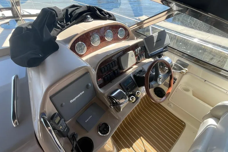 Slide: The Image of Helm of 2006 Sea Ray 360 Sundancer with navigation instruments and wooden steering wheel. - 9