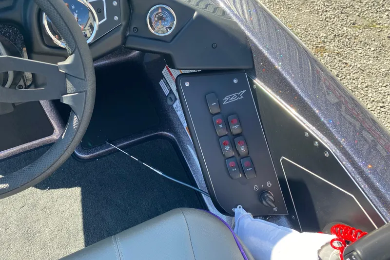 Slide: The Image of 2026 Skeeter ZX200 boat dashboard with control panel and steering wheel. - 11