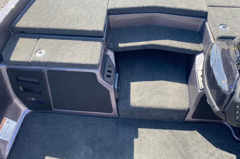 Slide: The Image of 2026 Skeeter ZX200 boat interior with carpeted deck and storage compartments. - 12