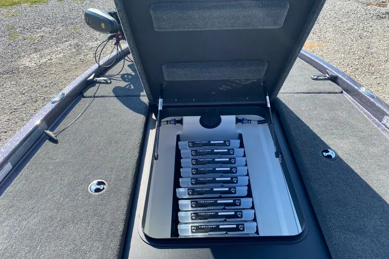 Slide: The Image of 2026 Skeeter ZX200 boat with open storage compartment revealing organized battery setup. - 16