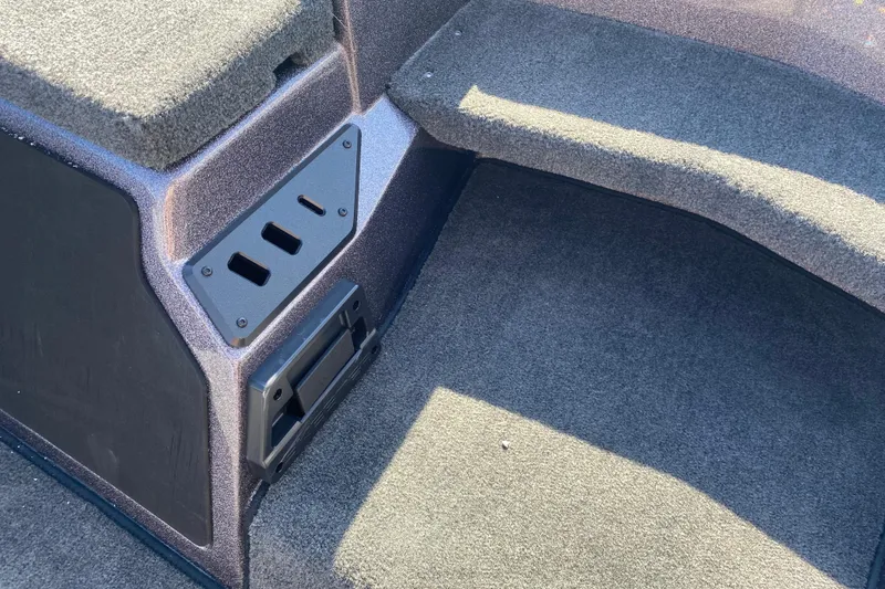 Slide: The Image of Interior view of 2026 Skeeter ZX200 boat, featuring carpeted flooring and storage compartments. - 19