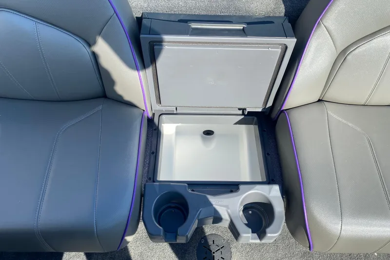 Slide: The Image of 2026 Skeeter ZX200 boat interior with open storage compartment and cup holders. - 21