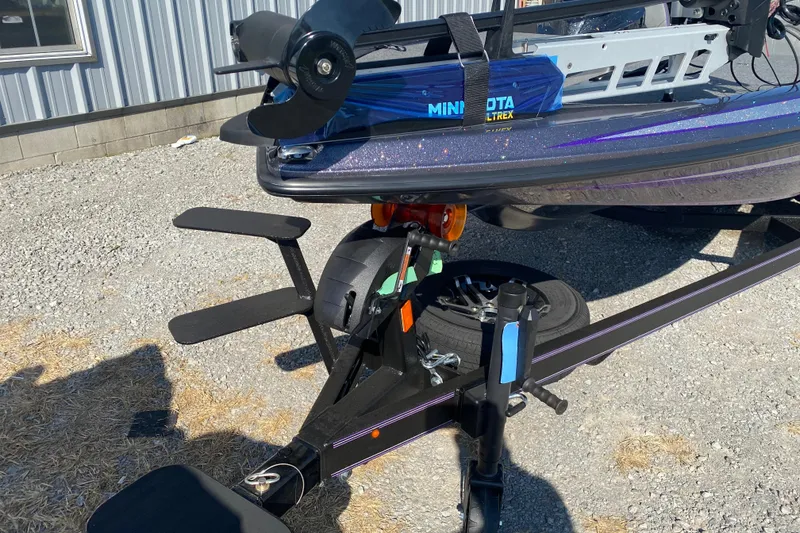 Slide: The Image of 2026 Skeeter ZX200 boat trailer with Minn Kota motor, parked on gravel. - 5