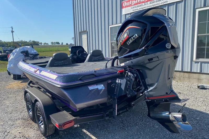 Slide: The Image of 2026 Skeeter ZX200 boat with Yamaha engine, parked outdoors near a building. - 9