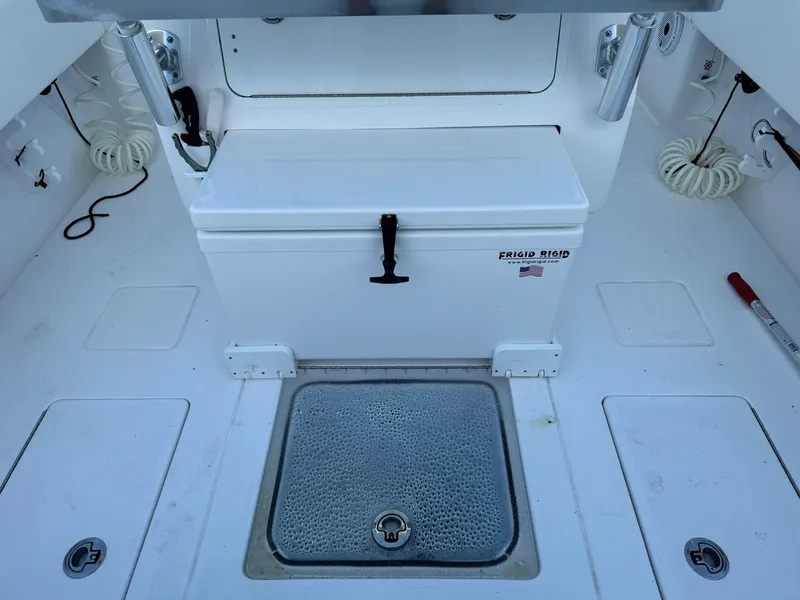 Slide: The Image of 2024 Contender 32 ST boat deck with storage compartments and cooler. - 11