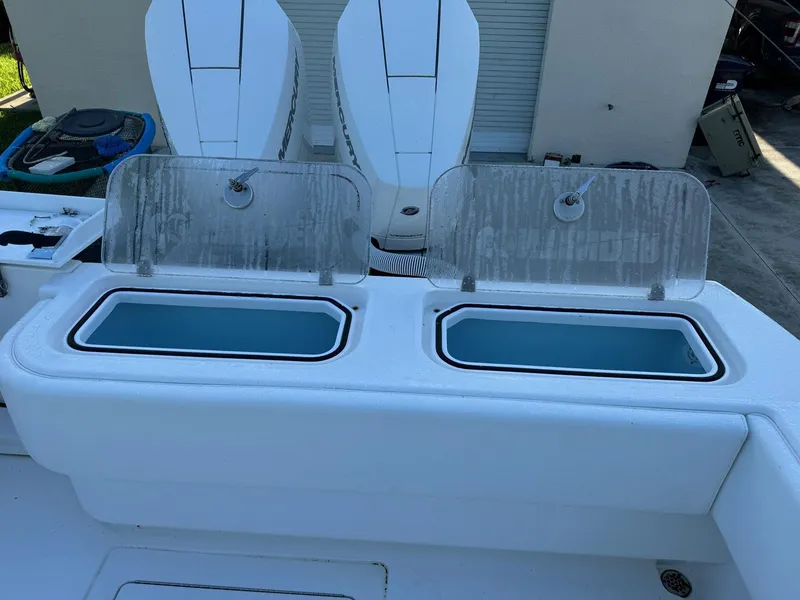 Slide: The Image of 2024 Contender 32 ST boat with dual livewells and outboard engines. - 12