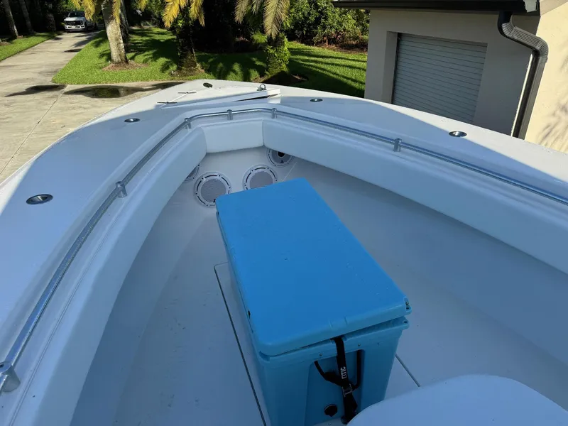 Slide: The Image of 2024 Contender 32 ST boat bow with blue cooler and speakers. - 2