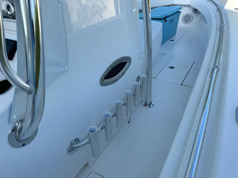Slide: The Image of 2024 Contender 32 ST boat interior with rod holders and storage compartments. - 4