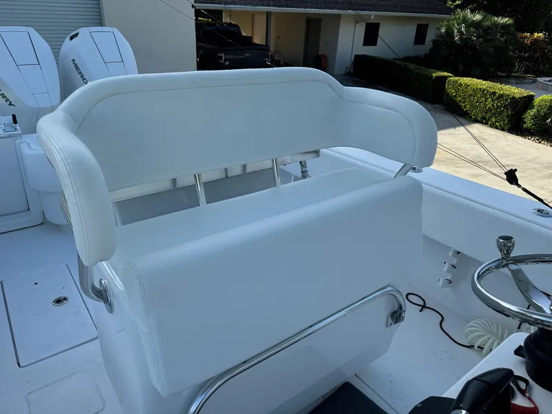 Slide: The Image of 2024 Contender 32 ST boat with white seating and steering wheel. - 7
