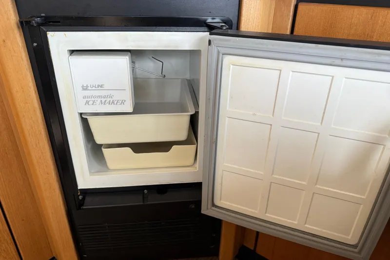 Slide: The Image of Luxurious beige leather seating with red cushion on 1999 Bayliner 3988 Command Bridge Motoryacht. - 14