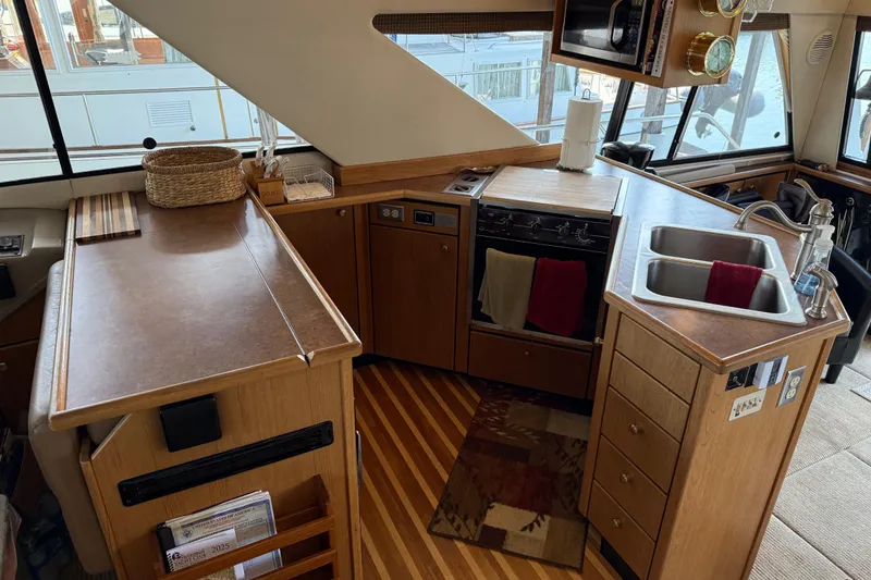 Slide: The Image of Built-in refrigerator on 1999 Bayliner 3988 Command Bridge Motoryacht, wood paneling. - 16
