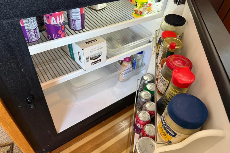 Slide: The Image of Interior of 1999 Bayliner 3988 Command Bridge Motoryacht kitchen with wood cabinetry and dual sink. - 19