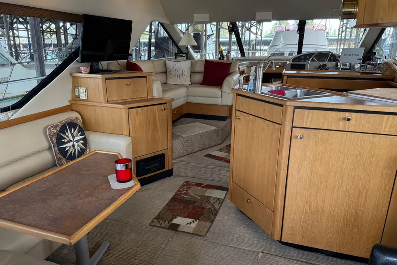 Slide: The Image of 1999 Bayliner 3988 Command Bridge Motoryacht docked in a marina under clear skies. - 2