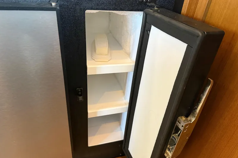 Slide: The Image of Interior of 1999 Bayliner 3988 Command Bridge Motoryacht with wooden cabinetry and magazine holder. - 20