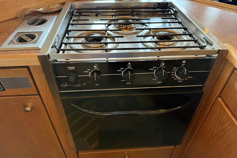 Slide: The Image of Stainless steel refrigerator on 1999 Bayliner 3988 Command Bridge Motoryacht, wooden cabinetry. - 21