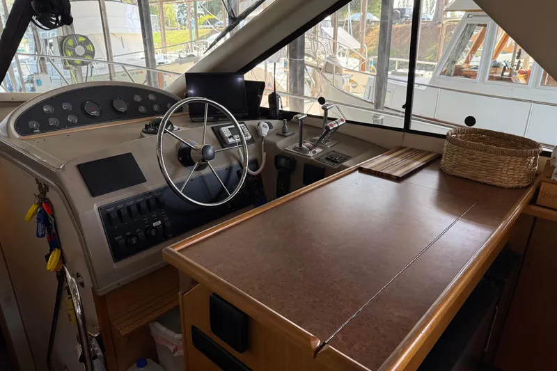 Slide: The Image of Open refrigerator on 1999 Bayliner 3988 Command Bridge Motoryacht, showing empty shelves and a butter dish. - 23