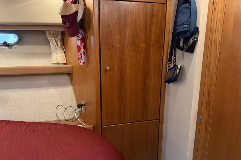 Slide: The Image of Wooden drawers inside 1999 Bayliner 3988 Command Bridge Motoryacht, featuring sleek design and metallic knobs. - 37