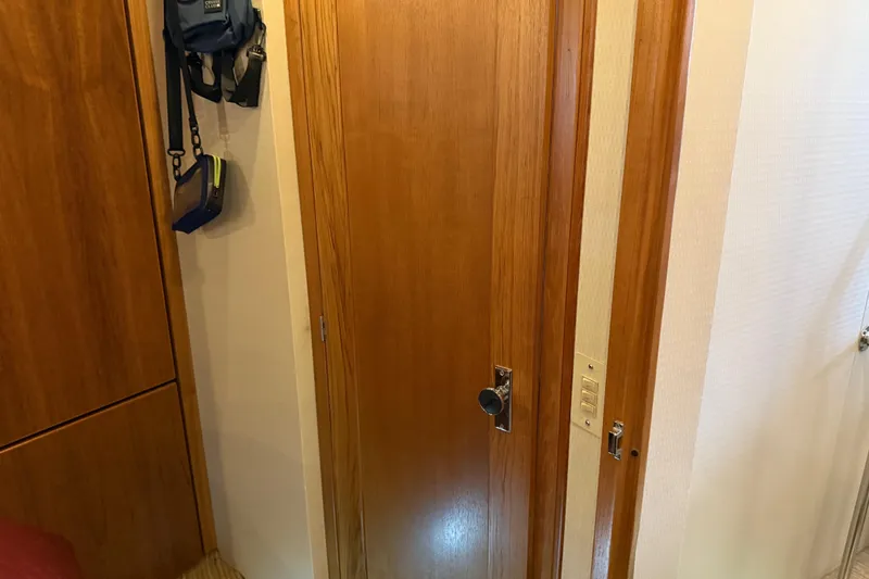 Slide: The Image of Closet interior on 1999 Bayliner 3988 Command Bridge Motoryacht with clothes and shoes. - 39