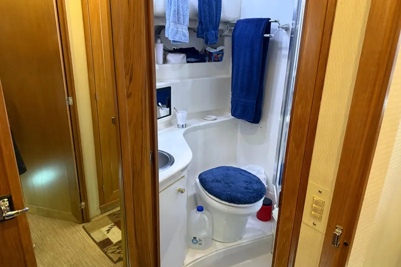 Slide: The Image of Interior of 1999 Bayliner 3988 Command Bridge Motoryacht with wooden cabinetry and red bedding. - 40