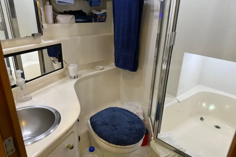 Slide: The Image of Closet interior on 1999 Bayliner 3988 Command Bridge Motoryacht with hanging clothes and accessories. - 41