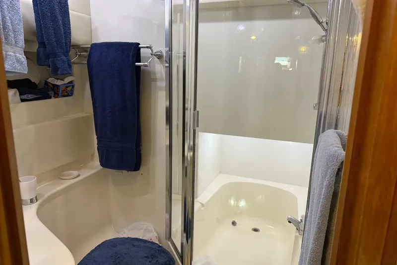 Slide: The Image of Interior of 1999 Bayliner 3988 Command Bridge Motoryacht with wooden door and hanging items. - 42