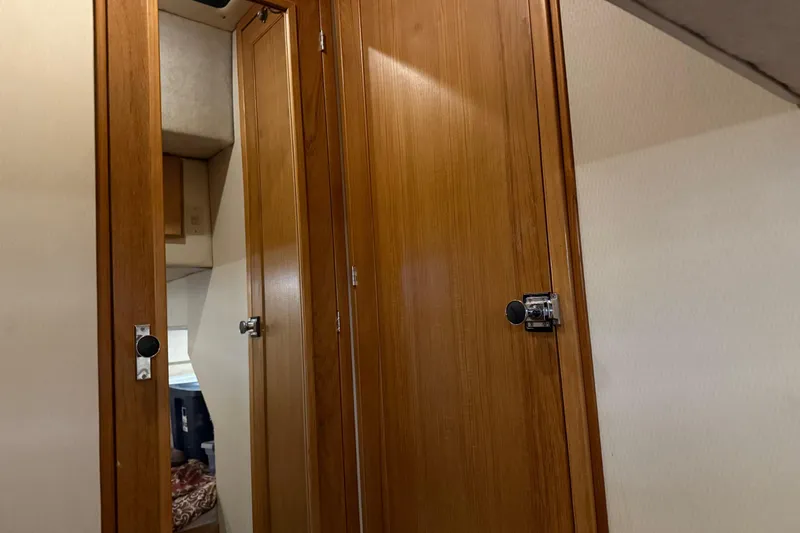 Slide: The Image of Wooden cabinet doors inside a 1999 Bayliner 3988 Command Bridge Motoryacht. - 52