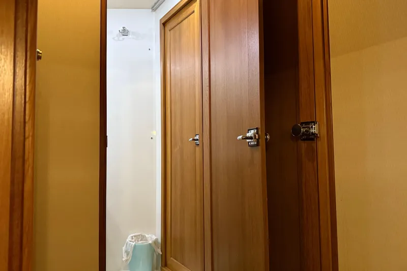 Slide: The Image of 1999 Bayliner 3988 Command Bridge Motoryacht interior storage compartment with open wooden cabinet. - 53