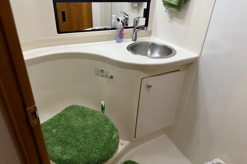 Slide: The Image of Cozy cabin interior of 1999 Bayliner 3988 Command Bridge Motoryacht with patterned bedding. - 54