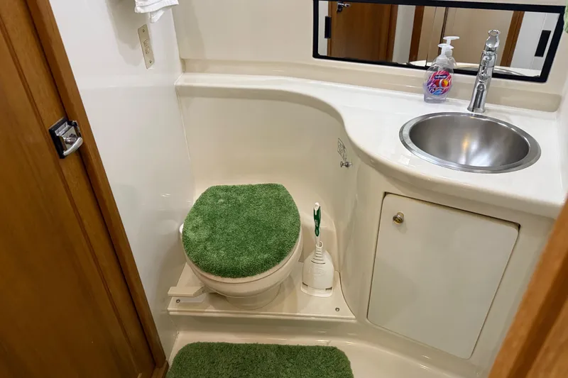 Slide: The Image of Interior of 1999 Bayliner 3988 Command Bridge Motoryacht with wooden doors and trash bin. - 56