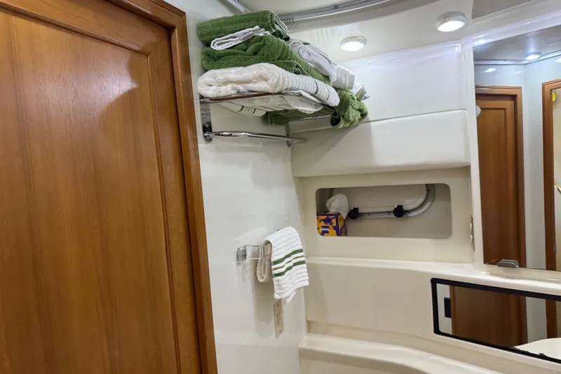 Slide: The Image of 1999 Bayliner 3988 Command Bridge Motoryacht bathroom with sink and green carpeted toilet seat. - 57