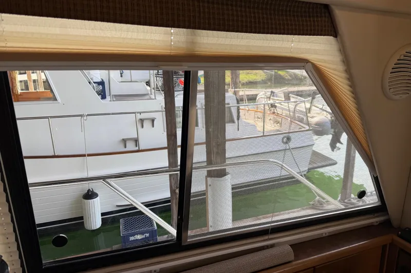 Slide: The Image of Interior of 1999 Bayliner 3988 Command Bridge Motoryacht with cozy seating and decorative pillows. - 6