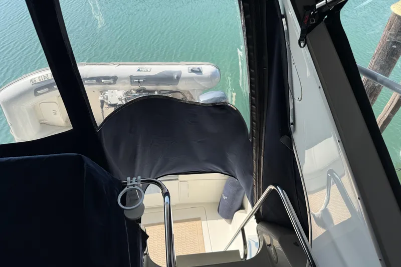 Slide: The Image of 1999 Bayliner 3988 Command Bridge Motoryacht dashboard with gauges, compass, and Garmin device. - 67