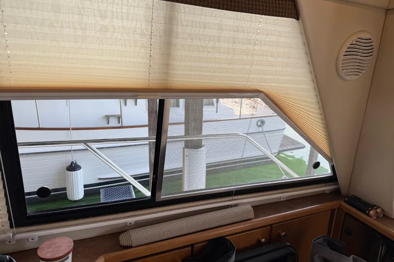 Slide: The Image of Interior of 1999 Bayliner 3988 Command Bridge Motoryacht with cozy seating and TV. - 7