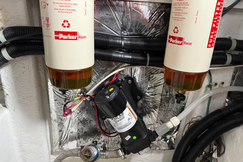 Slide: The Image of Engine room of 1999 Bayliner 3988 Command Bridge Motoryacht with visible hoses and components. - 75