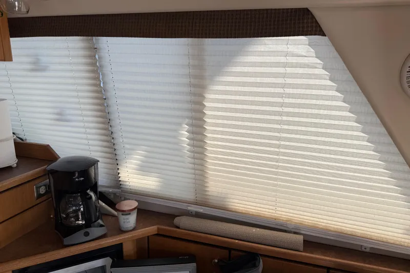 Slide: The Image of Interior of 1999 Bayliner 3988 Command Bridge Motoryacht with cozy seating and decorative pillows. - 8