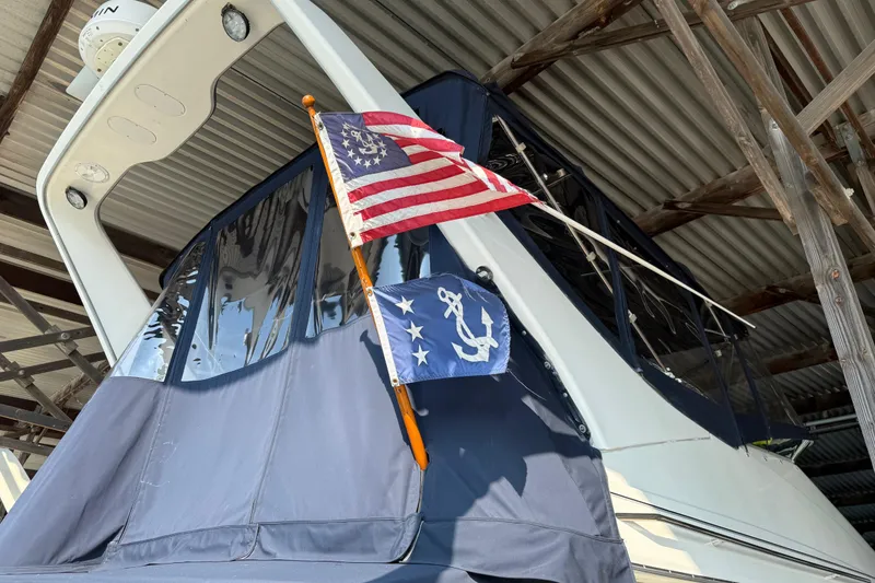 Slide: The Image of 1999 Bayliner 3988 Command Bridge Motoryacht helm covered with navy blue protective fabric. - 91