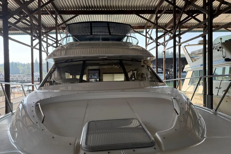 Slide: The Image of Carpeted interior of 1999 Bayliner 3988 Command Bridge Motoryacht, featuring metal table supports. - 93