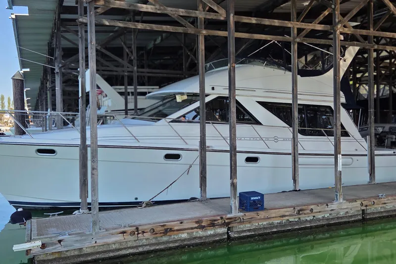 Slide: The Image of 1999 Bayliner 3988 Command Bridge Motoryacht docked in a marina. - 97